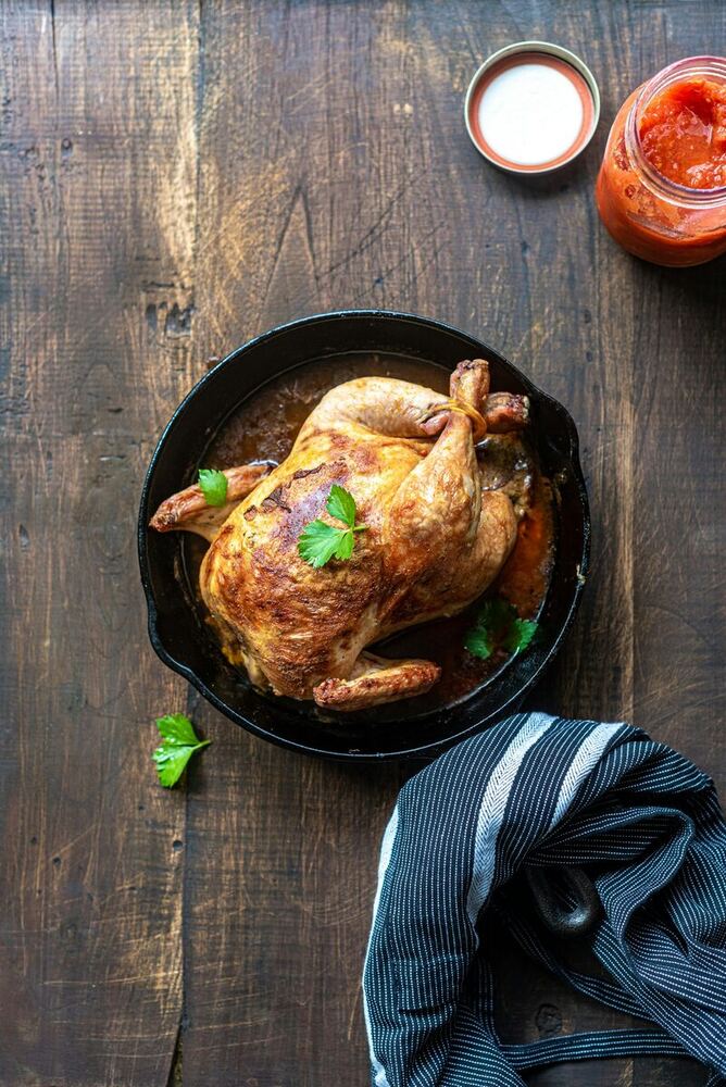 Saffron and lemon roast chicken in a cast-iron pan